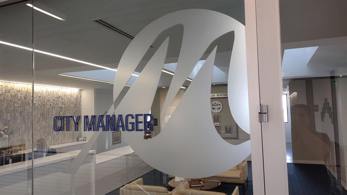 Glass office wall featuring stained City of Maricopa 