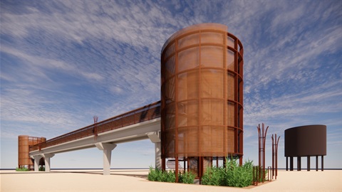 Futuristic pedestrian bridge with rust-colored cylindrical towers and mesh, set in a sandy landscape under a blue sky with wispy clouds.
