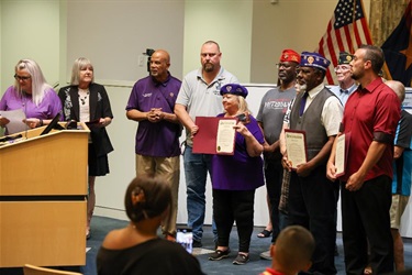 Maricopa Mayor Nancy Smith and City Council members pose with the Purple Heart Day proclamation during a council meeting.