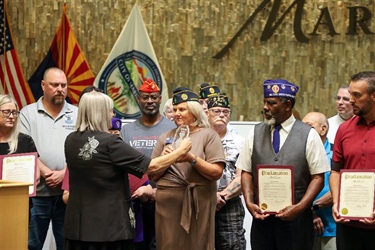 Maricopa Mayor Nancy Smith and City Council members pose with the Purple Heart Day proclamation during a council meeting.