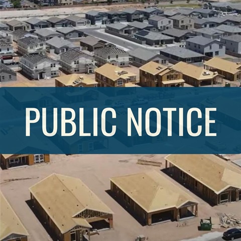 A large number of houses are being built in a residential area with the words 