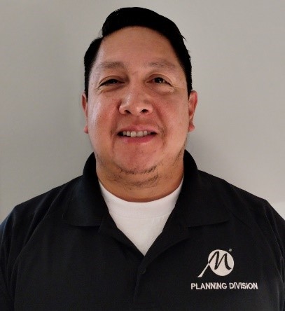 Photograph of a man with a black polo shirt with the City of Maricopa M logo and 